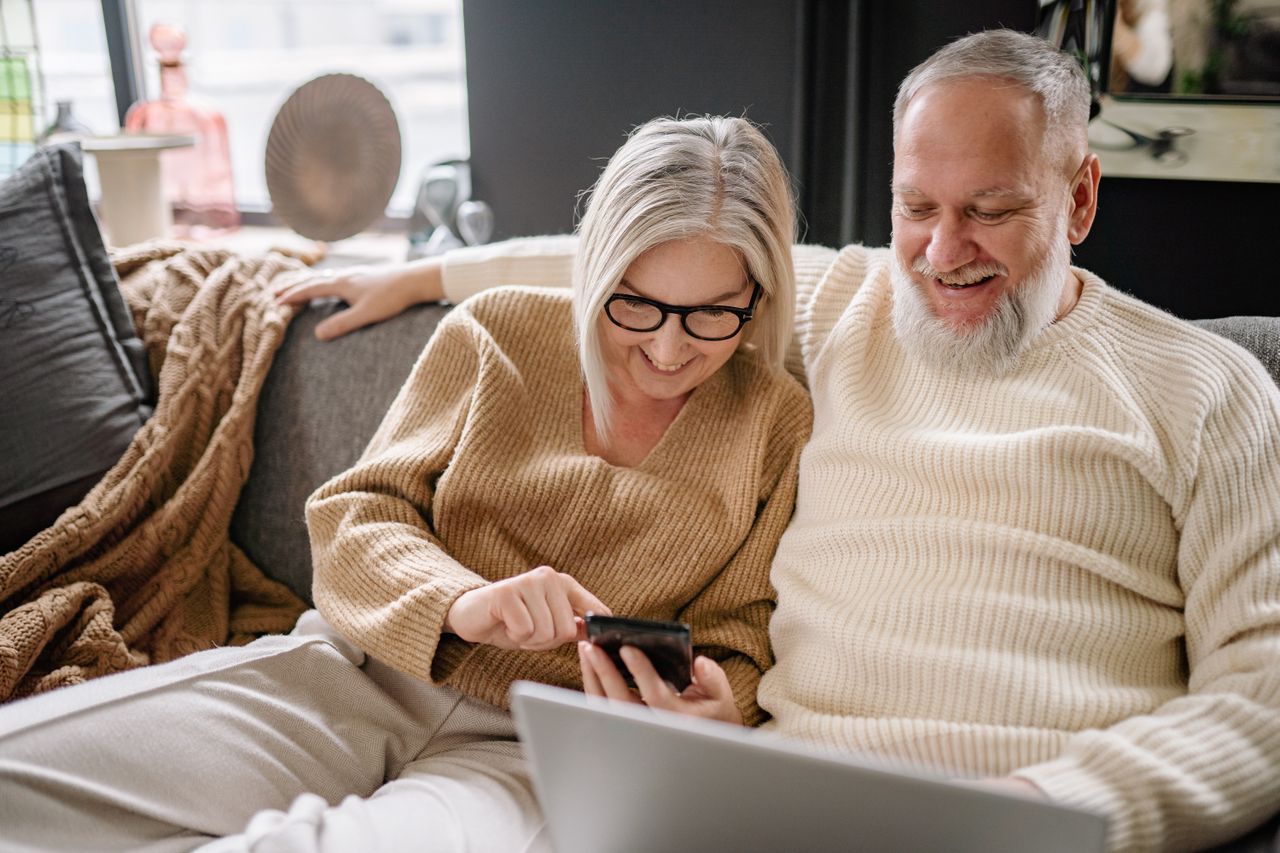 Elderly couple calling Citadel Gold for a free consultation on gold IRA pros and cons