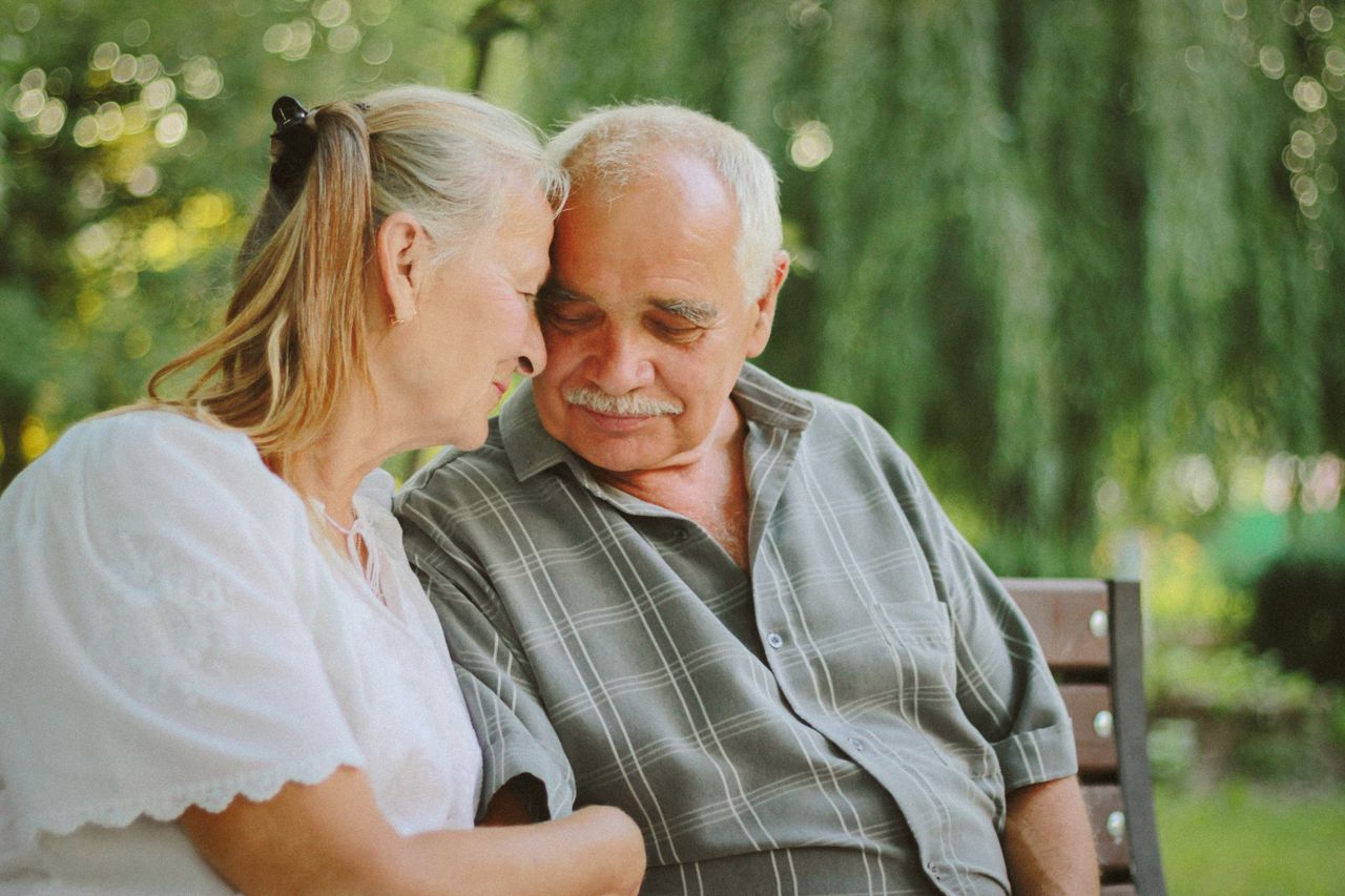 Elderly couple relaxing on a park bench