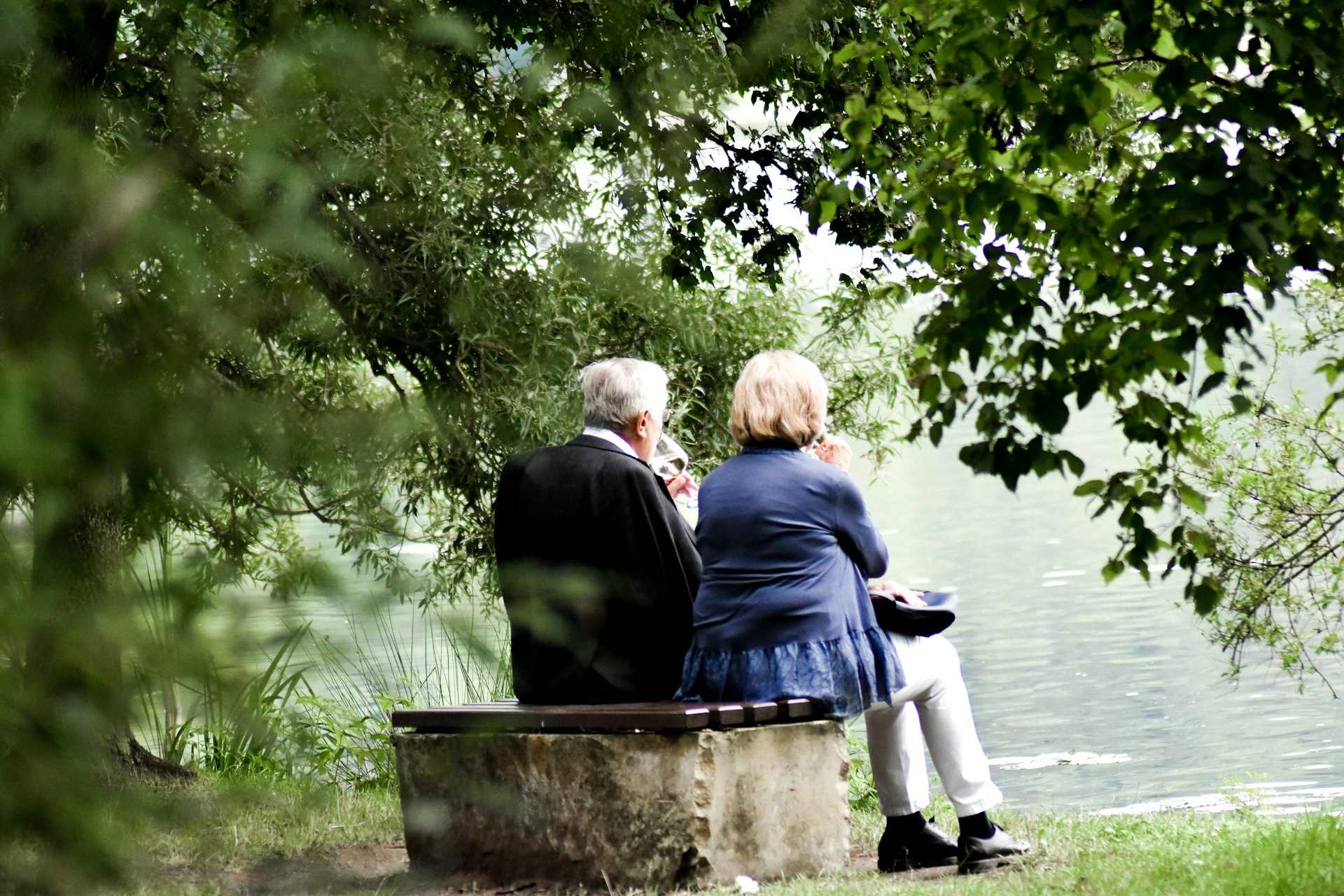 Elderly couple enjoying peace of mind outdoors, knowing their wealth is backed by the historical value of gold
