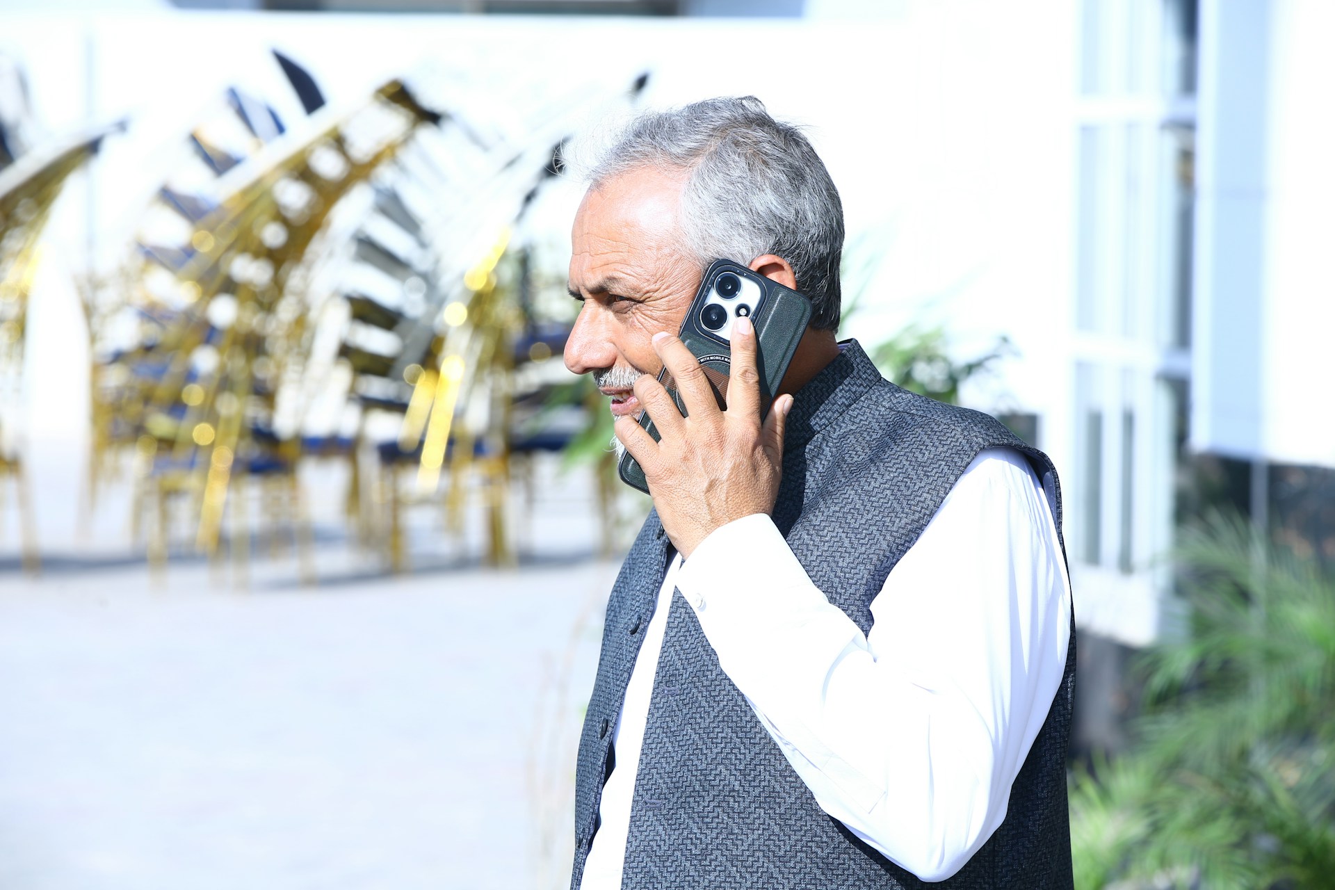 Elderly man on a phone consultation about the value of gold ownership