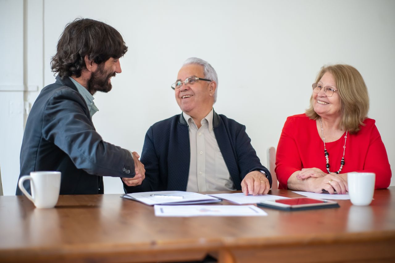Elderly couple discussing wealth preservation planning with a precious metals specialist