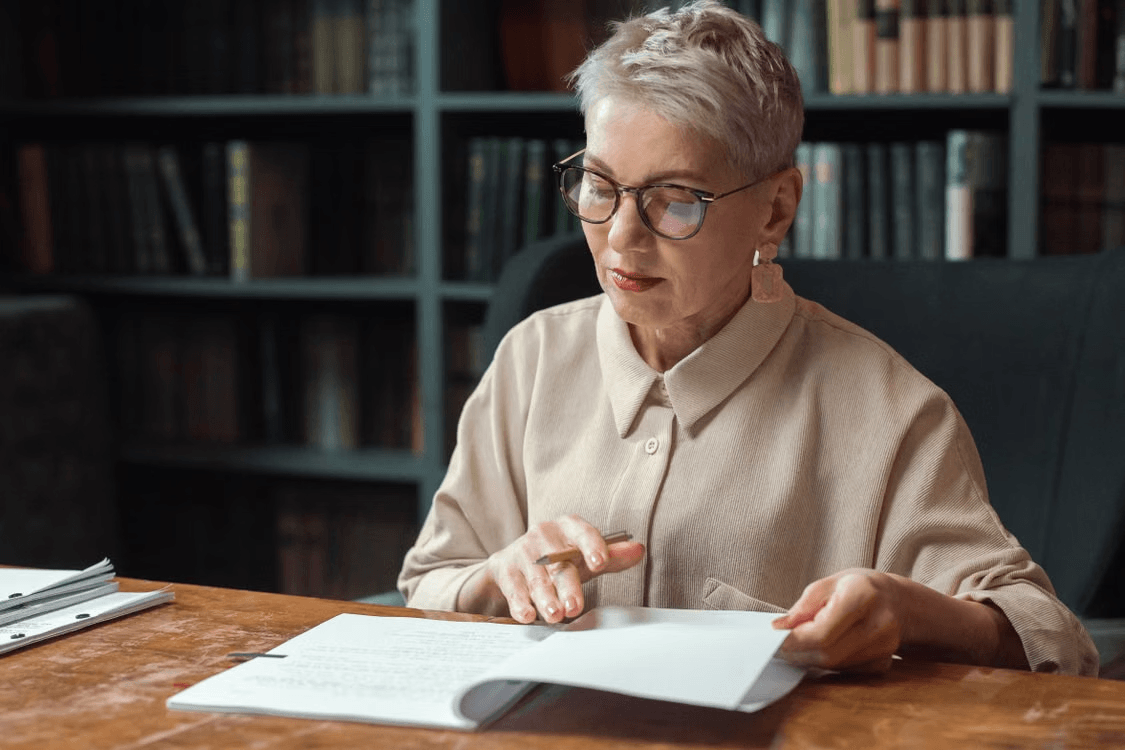 Elderly woman gaining investment knowledge through diligent research