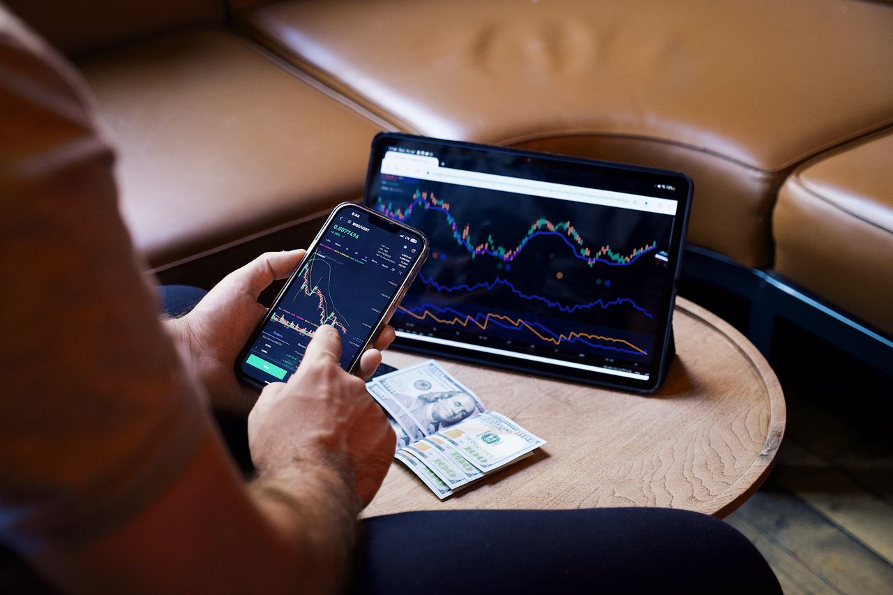 Person looking at stock market charts while wealth preservation planning