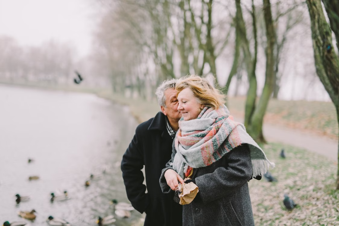 Happy elderly couple outside enjoying the peace of mind that comes with direct ownership of gold